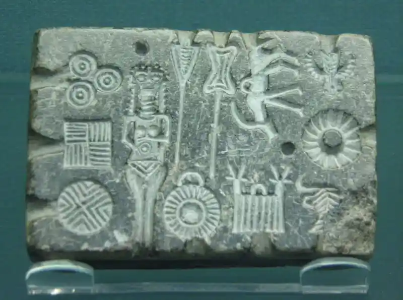 Naked woman, solar discs, and crosses on a stone mold